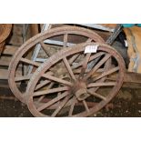 A pair of wooden cart wheels, together with axle