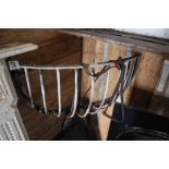 An iron corner hay rack, part of a bridle etc.