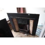 A cast iron fireplace with Art Nouveau tiles