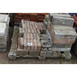 A pallet comprising bricks and concrete edging blo