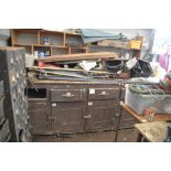 A large pine work bench with drawers and cupboards