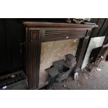 A stained pine fire surround & cast iron insert.