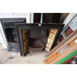 A cast iron fireplace with Minton tiles and marble
