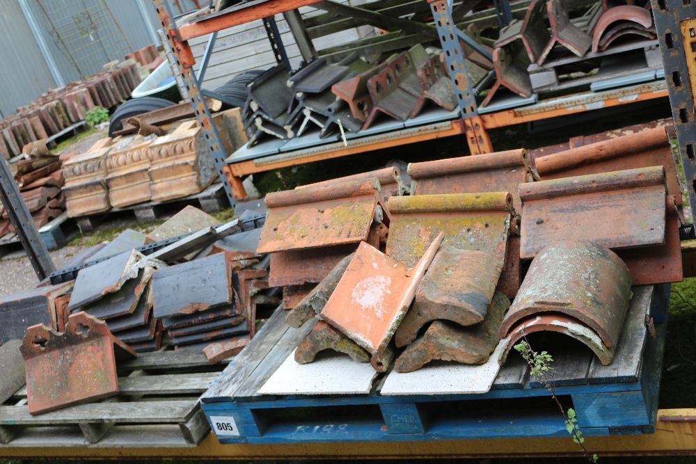 A quantity of various terracotta ridge tiles