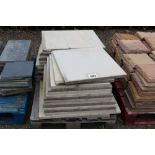 A pallet of large paving slabs