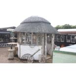 A timber, brick and thatched garden gazebo, (purch