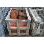 A crate of terracotta roofing tiles