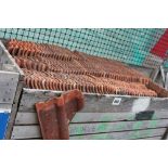 A crate of terracotta roofing tiles