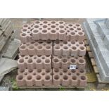 A pallet of perforated path blocks