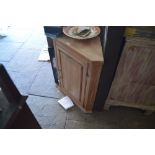 A stripped pine hanging corner cabinet