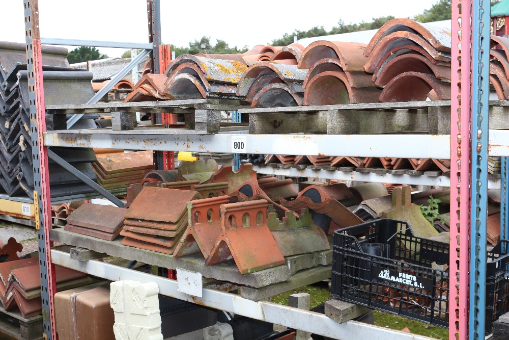 A large quantity of mostly terracotta ridge tiles,