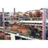 A large quantity of mostly terracotta ridge tiles,