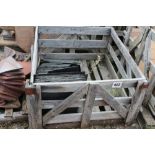 A crate of miscellaneous slate tiles