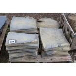 A pallet containing shaped concrete paving slabs