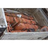 A crate of terracotta roofing tiles