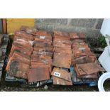 A pallet of terracotta peg tiles