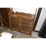 An oak and leaded glazed hanging display cabinet