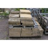 A pallet of concrete paving slabs