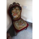 A Victorian walnut framed nursing chair