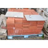 A pallet of red bricks