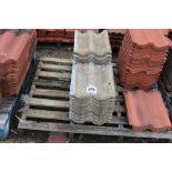 A mixed pallet of red and concrete roof tiles