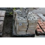 A pallet of concrete pierced wall blocks and a qua