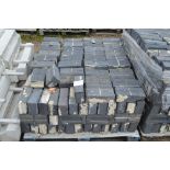 A quantity of black stable bricks