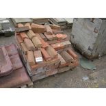 A pallet of old red plinth bricks