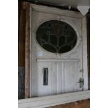 A large door and frame with an Art Nouveau lead gl