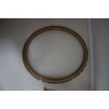 An oval gilt picture frame