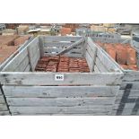 A crate containing a quantity of roof tiles