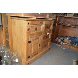 A stripped pine side cabinet