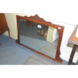 An Edwardian carved walnut wall mirror