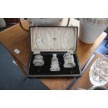 A cased cut glass cruet set