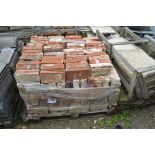 A pallet of old red bricks
