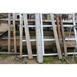 A rack with a large quantity of 9'x3' timber boarding and step la