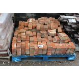 A pallet of red brick window surrounds