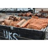 A crate of various shaped Romane roof tiles