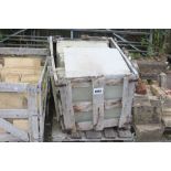 A crate of large Indian sandstone paving slabs