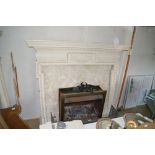 A metal fireplace with painted wooden surround and