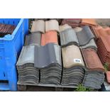 Various mixed concrete roof tiles of varying colou