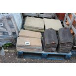 A pallet of black pantiles, concrete slabs etc.