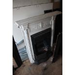 A painted cast iron bedroom fireplace