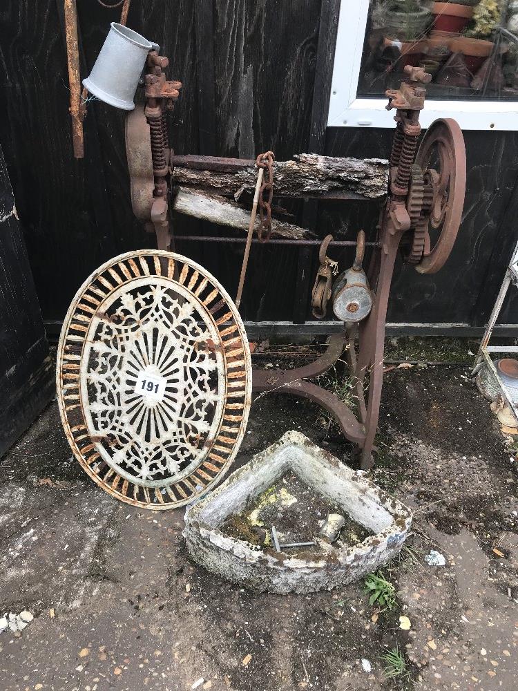 A cast iron wheel, old trough and mangle