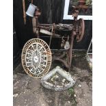 A cast iron wheel, old trough and mangle