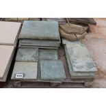 A pallet of various sized bluestone slabs and othe