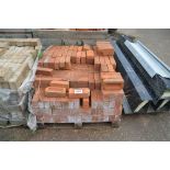 A pallet of red bricks