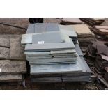 A pallet of grey and green slate slabs.