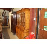 A reproduction yew wood display cabinet raised on t