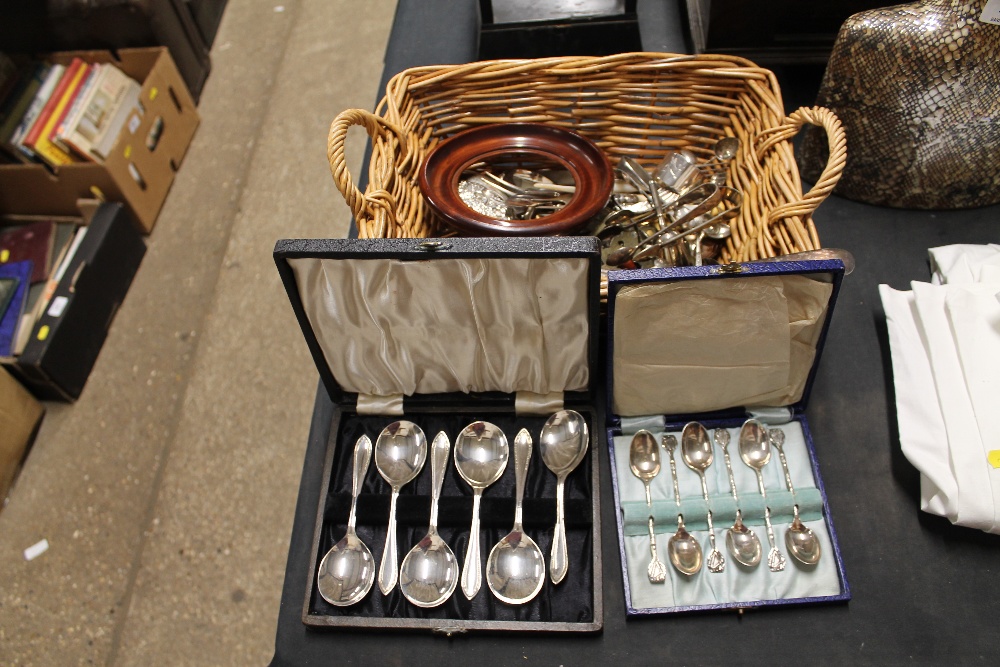 A basket of various cutlery and serviette rings; a